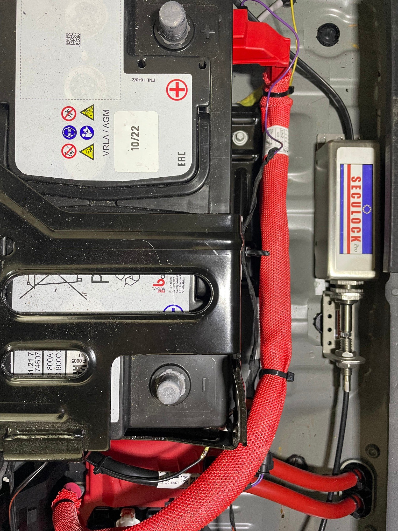 Close-up of Seculock Pro lock installation near the vehicle battery